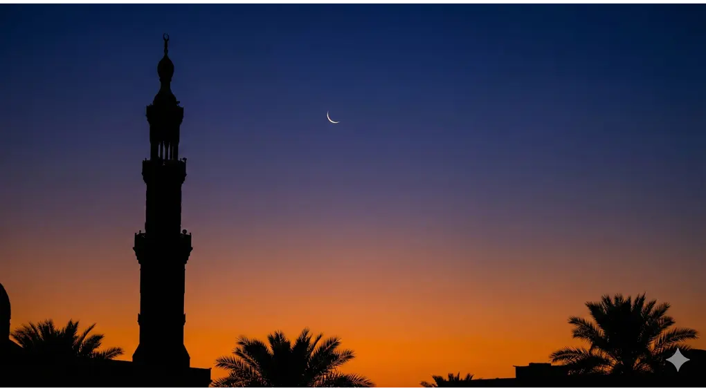 A thin crescent moon (hilal) visible at twilight above the silhouette of a mosque minaret, illustrating the lunar basis of the Hijri calendar where the new day begins at Maghrib.