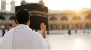 Home 3 A male worshipper prays with deep devotion before the Kaaba in Masjidil Haram, Mecca, at dusk.