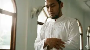 Home 31 A Muslim standing humbly with folded hands, showing the correct posture while reciting the Iftitah prayer during Salah.