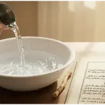 A modestly dressed Muslim woman in a proper hijab sitting reverently, holding a Quran in a bright mosque.