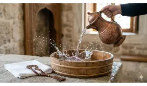 Shafi'i School of Jurisprudence: The Complete Guide to Islamic Law, Prayers, and Tasawuf 7 Crystal-clear water being poured from a classic copper pitcher into a wooden basin for thaharah preparation.