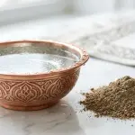 A copper bowl of absolute water next to pure earth for purifying najis mughallazah.