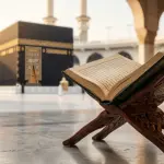 The Legal Basis of Hajj and Umrah in Islamic Jurisprudence An open classical Fiqh book with the Kaaba in the background symbolizing the legal basis of Hajj and Umrah.