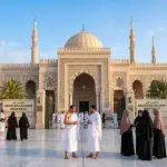 Hajj and Umrah pilgrims preparing and wearing ihram garments at the Miqat Mosque of Dzul Hulaifah in the morning.