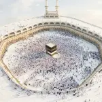 Wisdom of Hajj: Thousands of pilgrims wearing white ihram garments performing tawaf around the Kaaba in Masjid al-Haram.